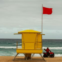 Warning flag on beach with lifeguard