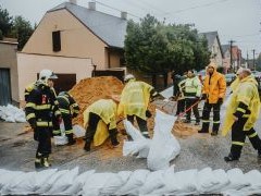 Image of people preparing sand bags for a flood