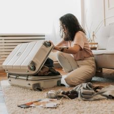 WOman packing a suitcase preparing alone for an emergency