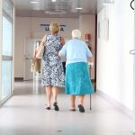 Image of senior citizen being helped