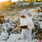 Man standing in hazardous waste in a HAZMAT suit